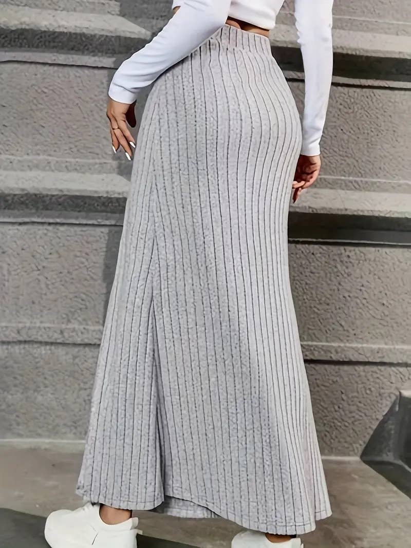 SLIT SLIT BUTTONS ADORN A DRAPED HIP SKIRT