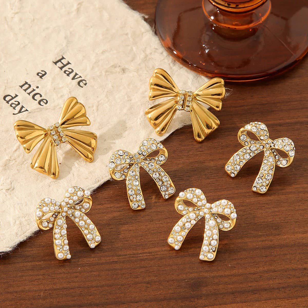 TITANIUM STEEL BOW EARRINGS INLAID WITH RHINESTONES