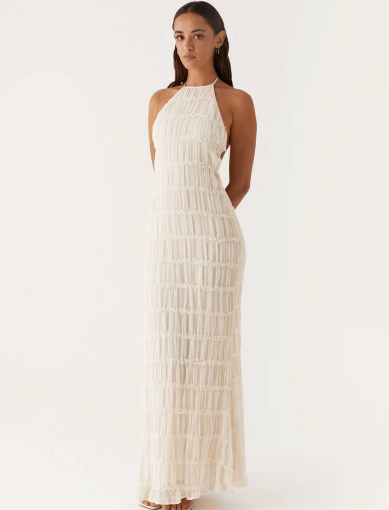 A long dress with a halter strap and pleated lace