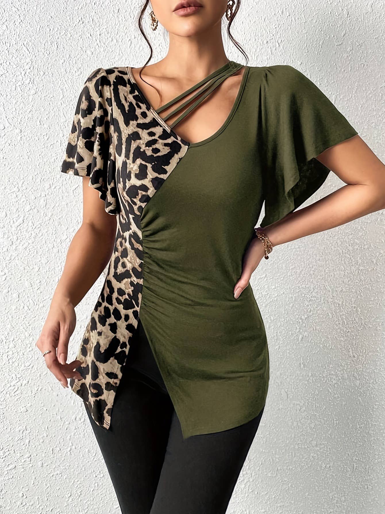 A leopard print asymmetrical collar patchwork top