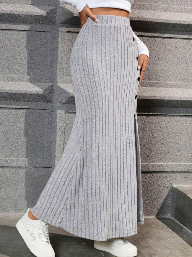 SLIT SLIT BUTTONS ADORN A DRAPED HIP SKIRT