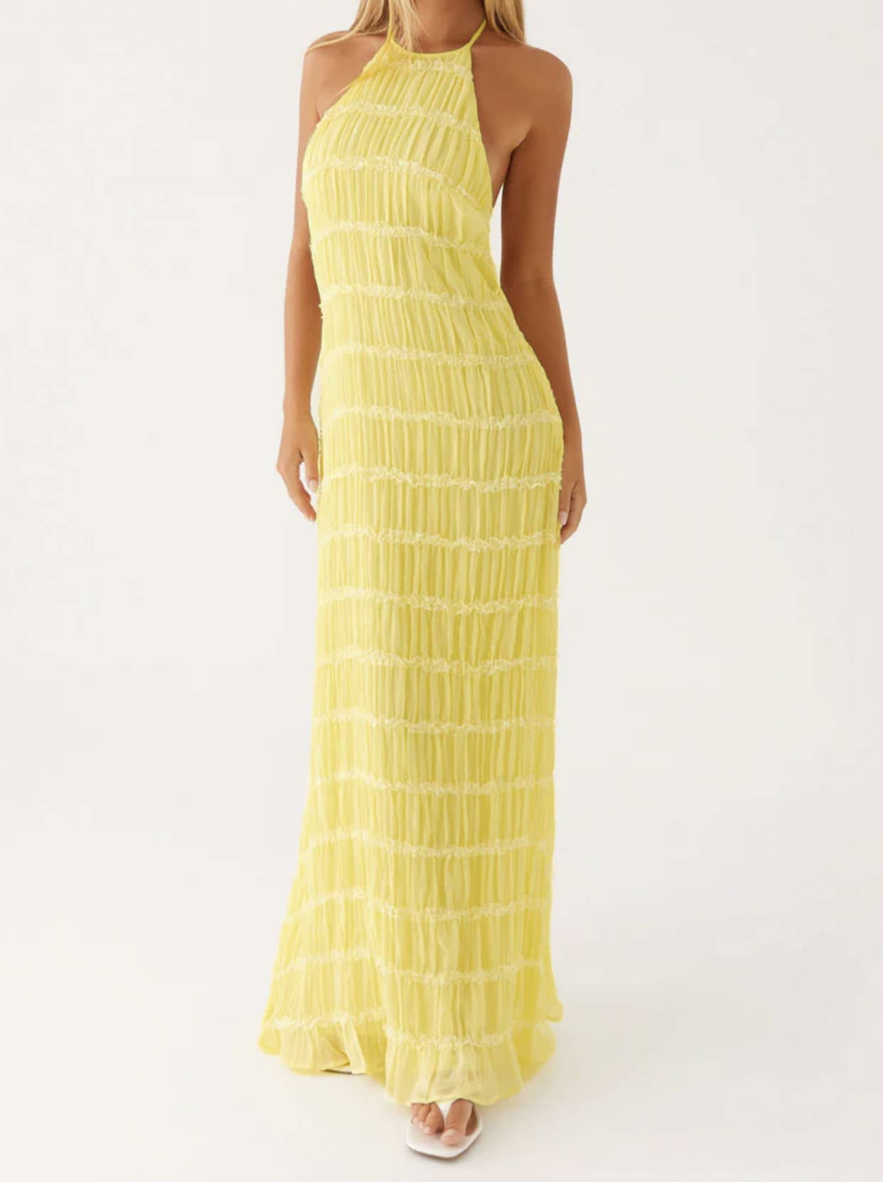 A long dress with a halter strap and pleated lace