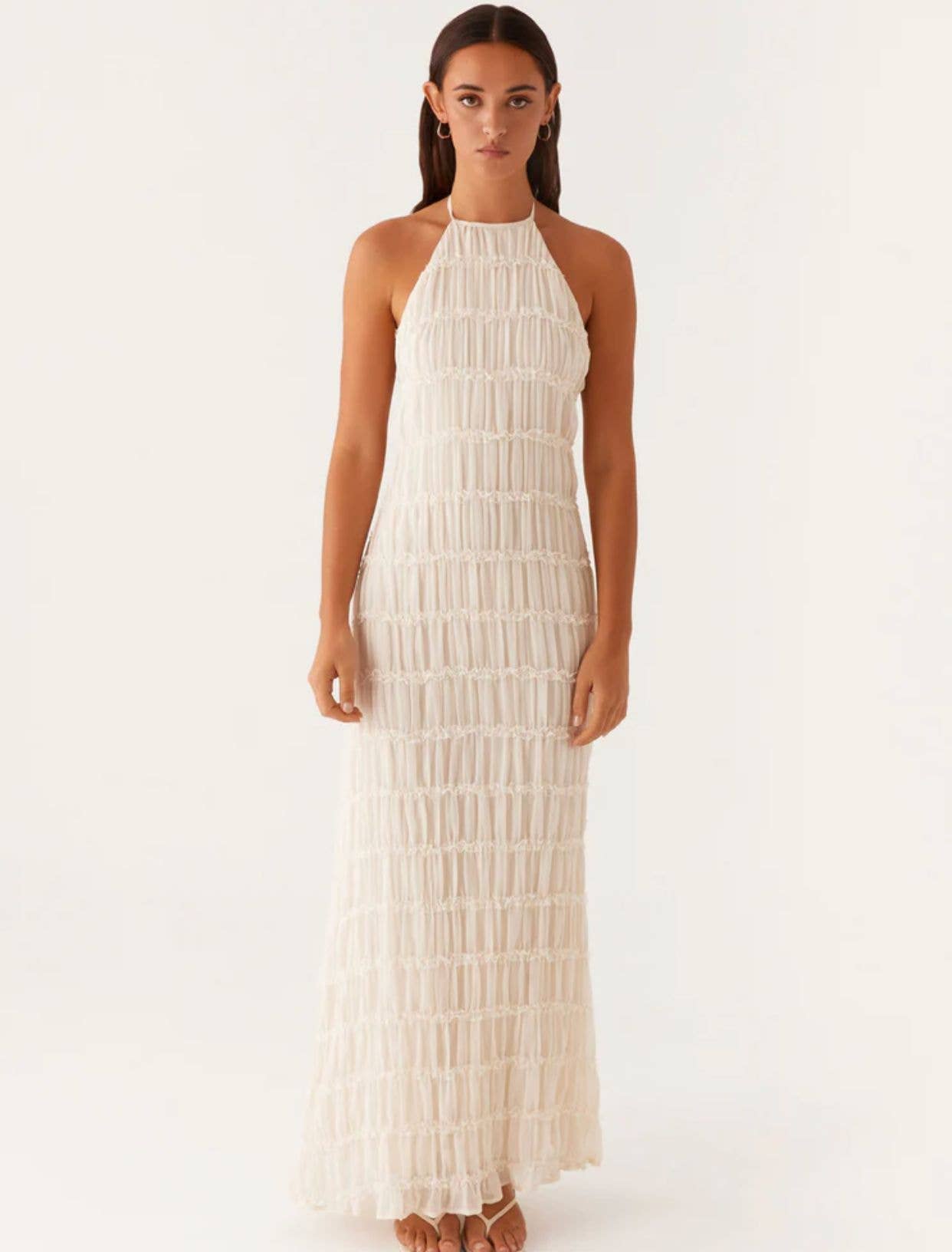 A long dress with a halter strap and pleated lace