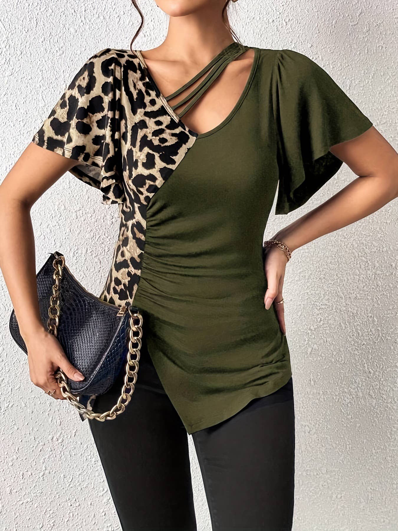 A leopard print asymmetrical collar patchwork top