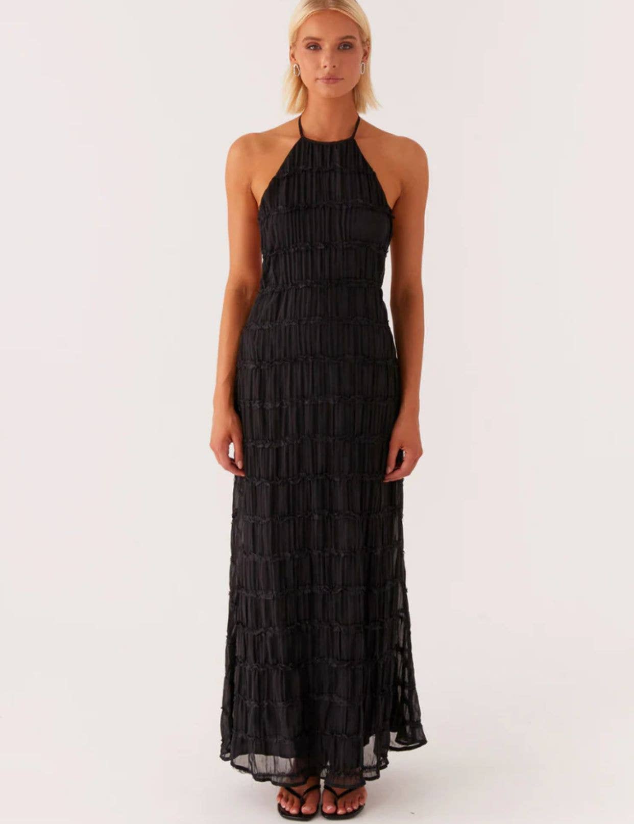 A long dress with a halter strap and pleated lace