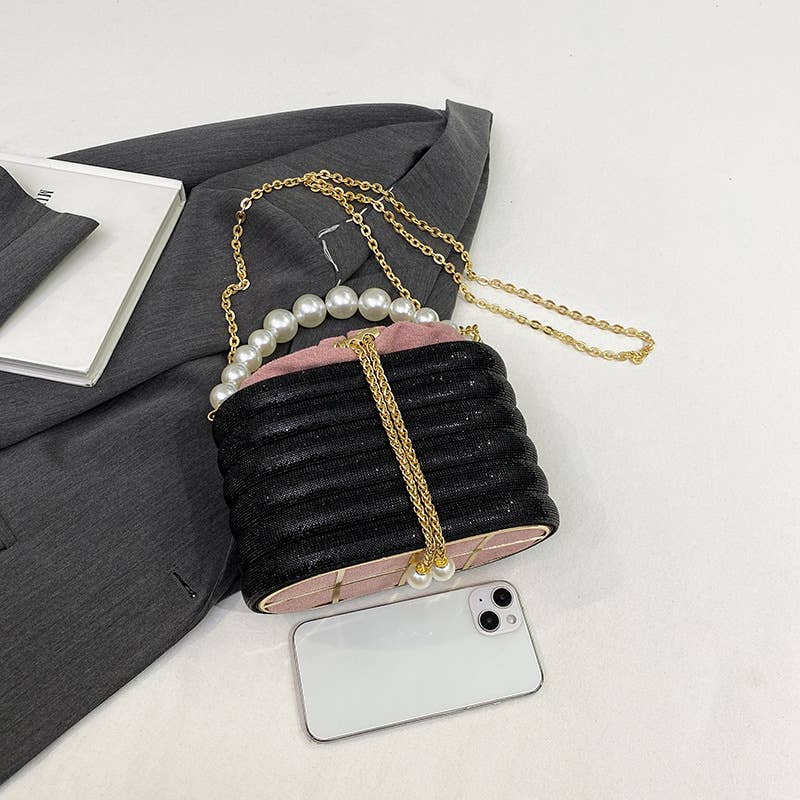 Slung over a pearl sparkling handbag