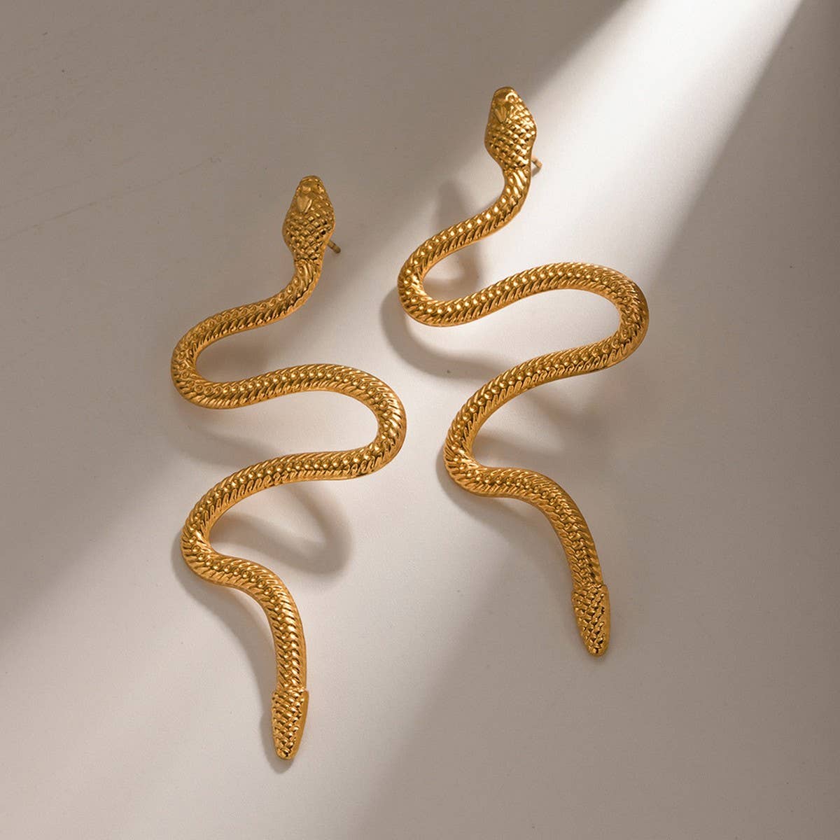 GOLD CURVED SNAKE DESIGN TITANIUM EARRINGS