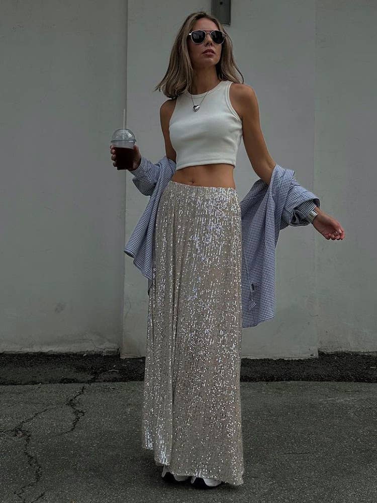 A long straight skirt in golden thread sequins