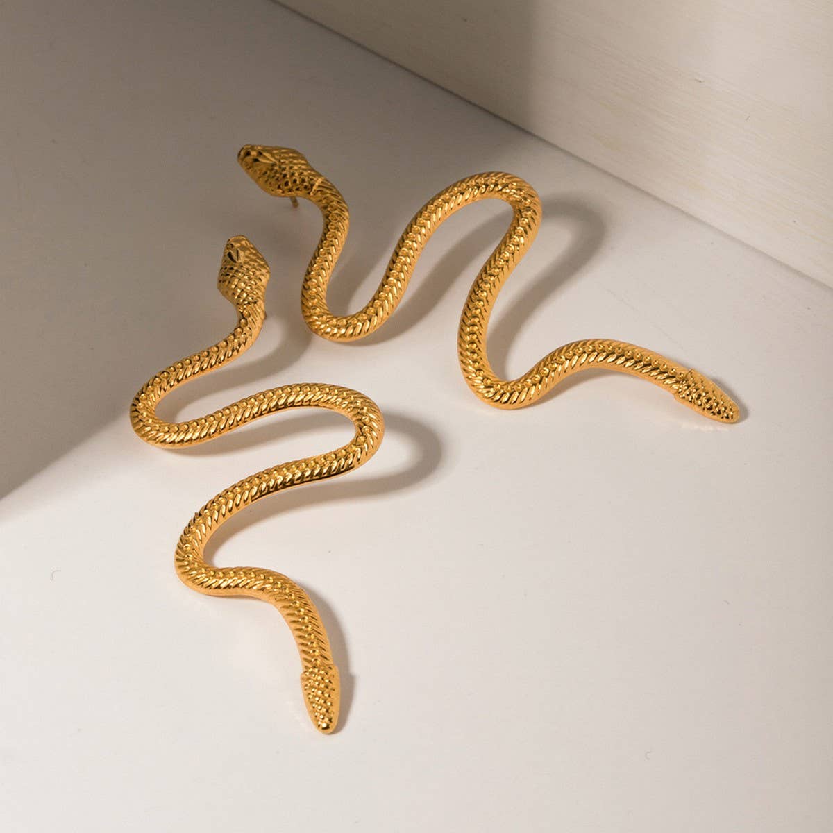 GOLD CURVED SNAKE DESIGN TITANIUM EARRINGS
