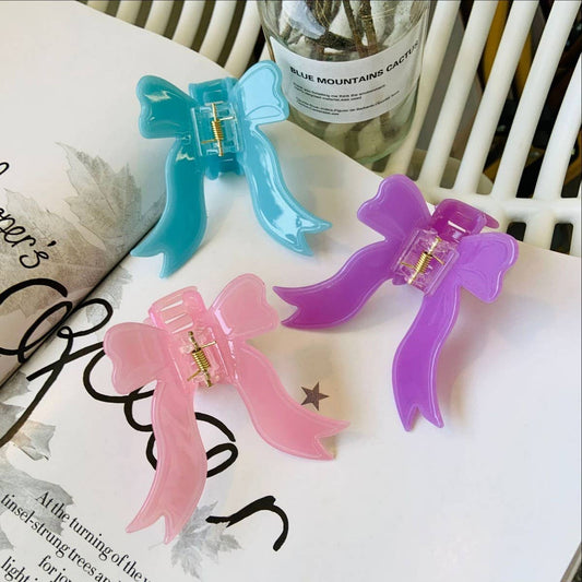 CWAHA1545_SOLID COLORED BOW STREAMERS HAIR CLAW CLIP