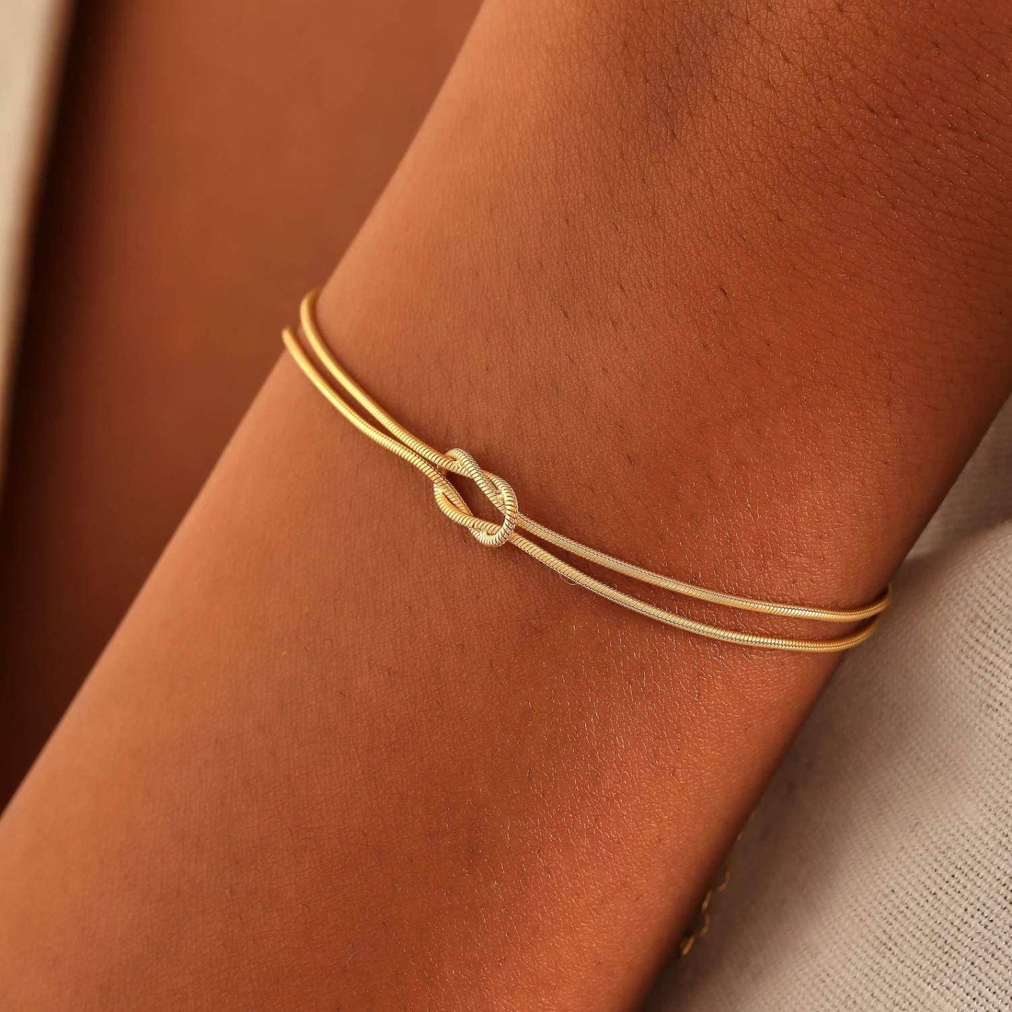 Brass love knot snake bone bracelet