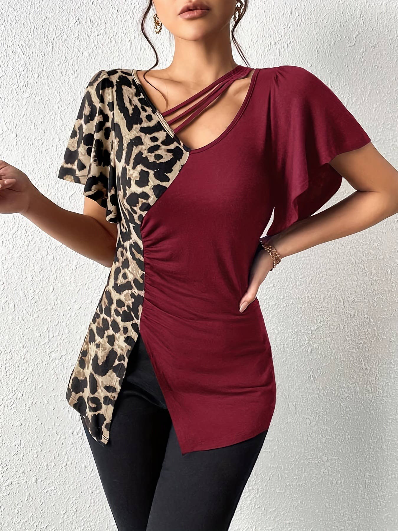 A leopard print asymmetrical collar patchwork top