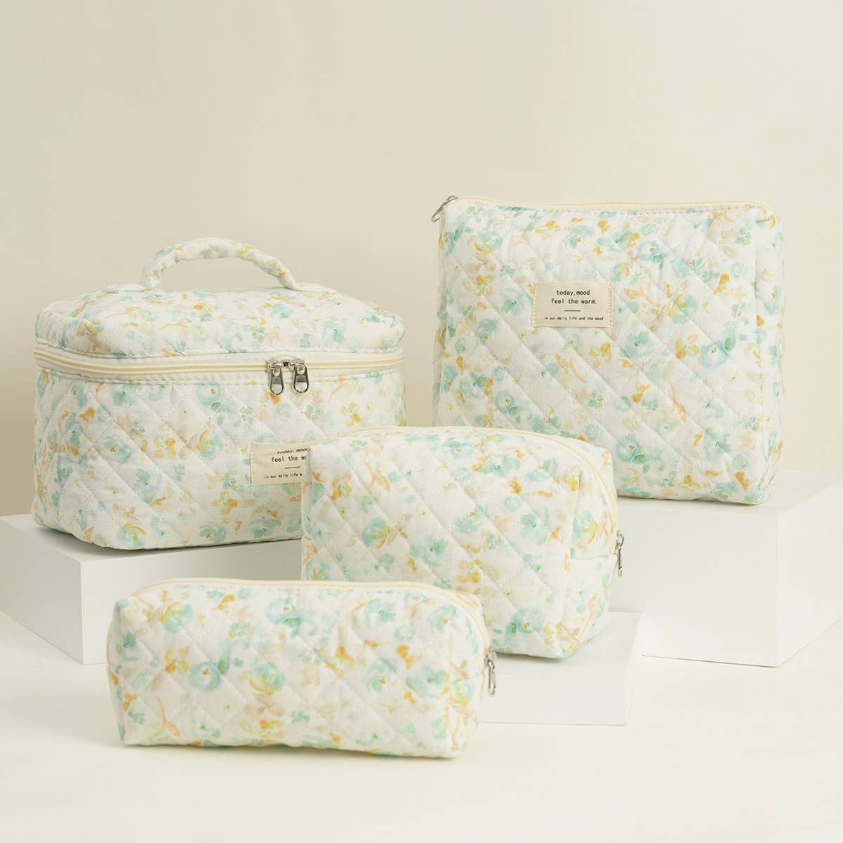 Four-piece set of quilted floral makeup bags