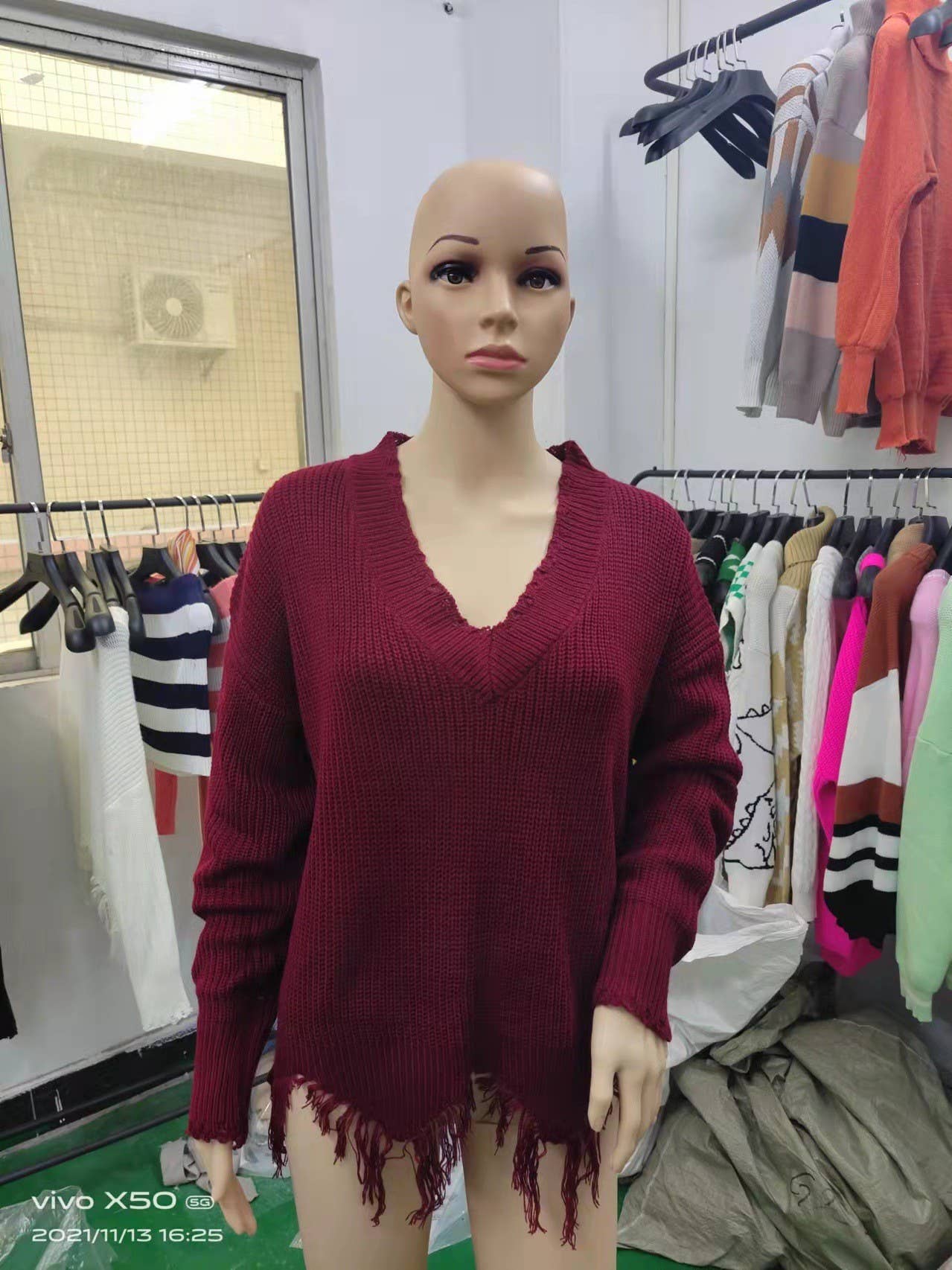 KNIT SWEATER WITH LARGE V-NECK FRINGE HEM