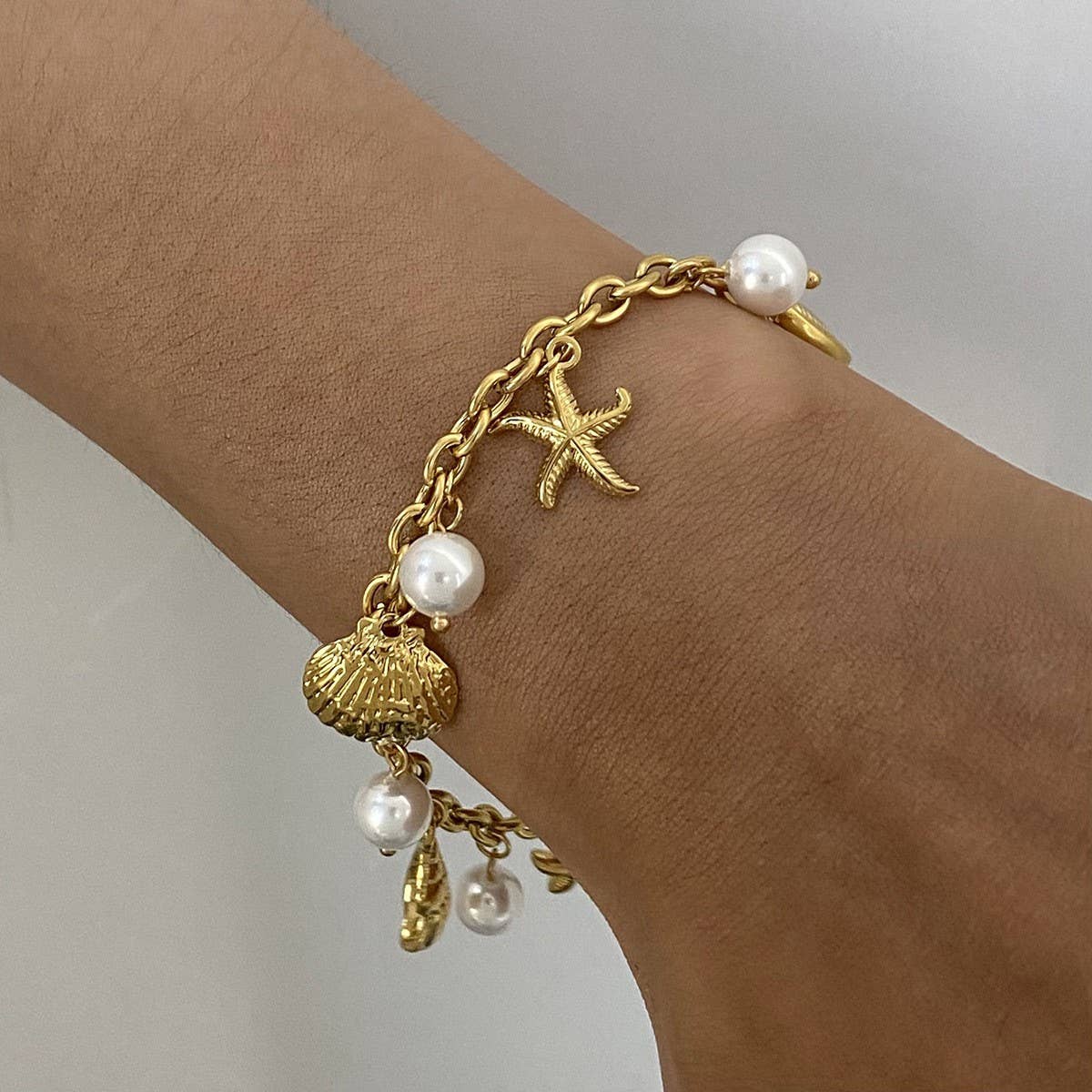 18K Gold Sea Charm Bracelet in Stainless Steel_CWAJE4641