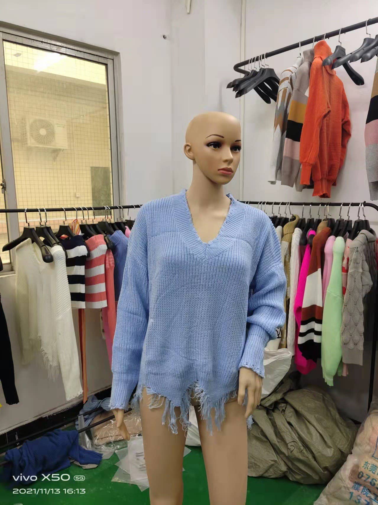 KNIT SWEATER WITH LARGE V-NECK FRINGE HEM