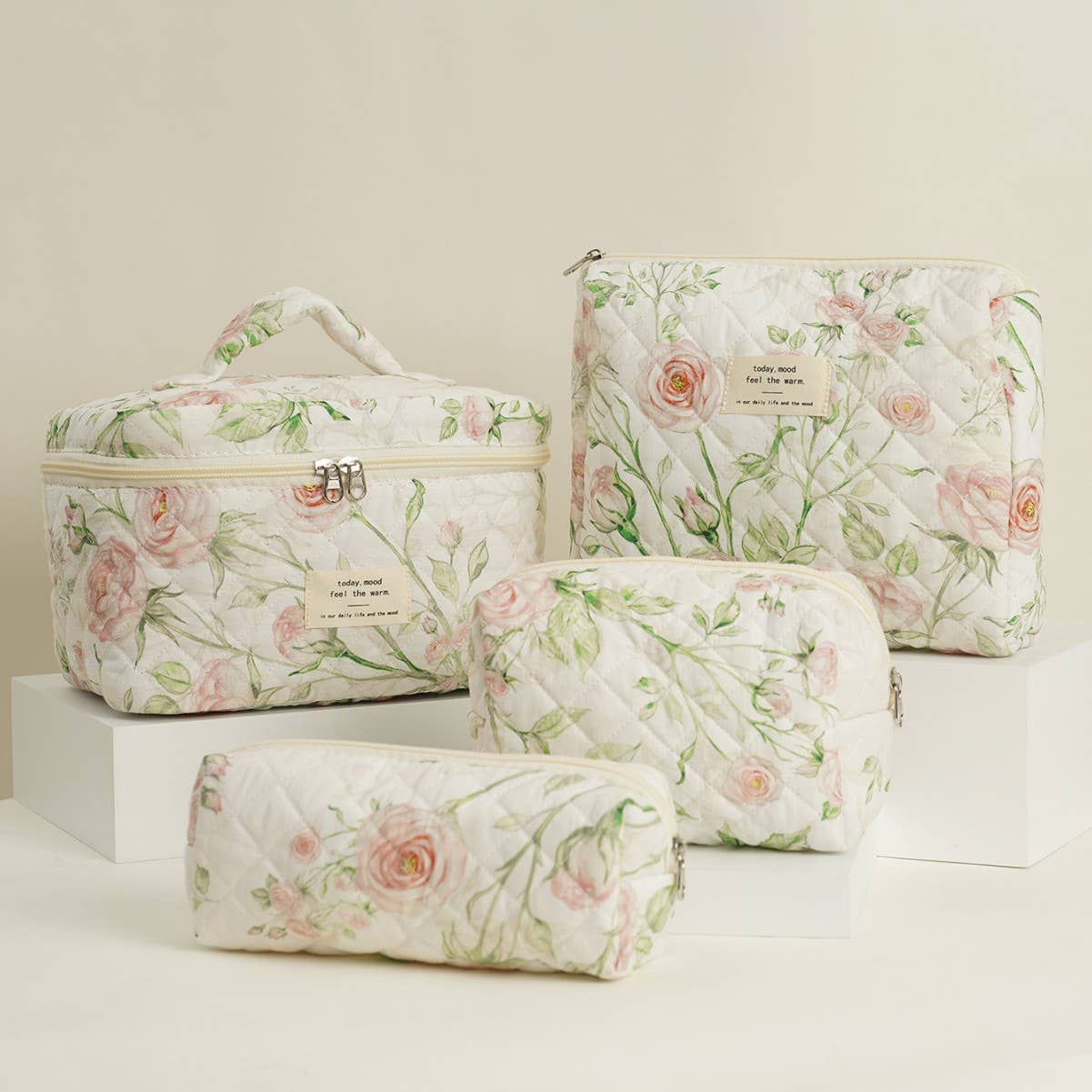 Four-piece set of quilted floral makeup bags