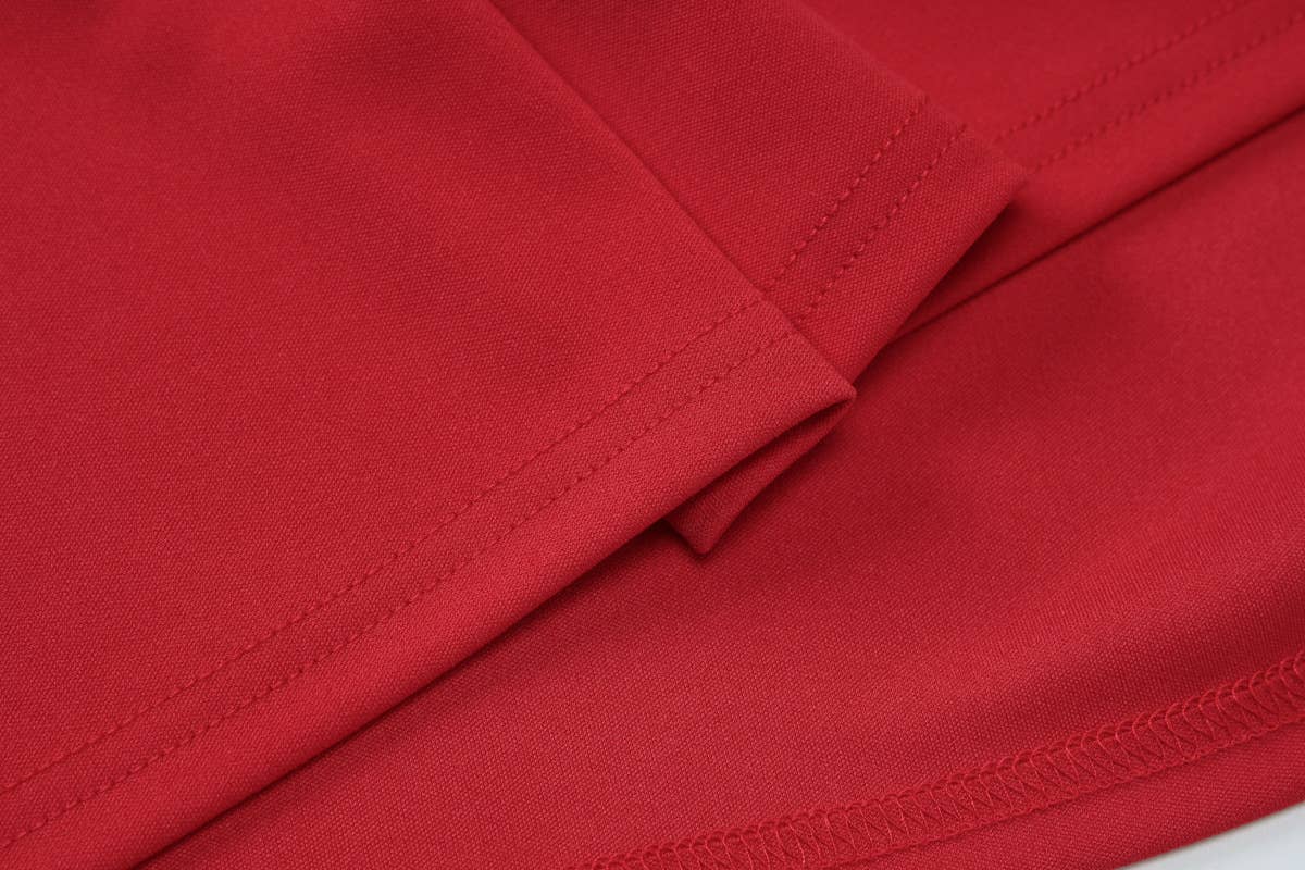 A halter, backless, high-waisted pleated dress