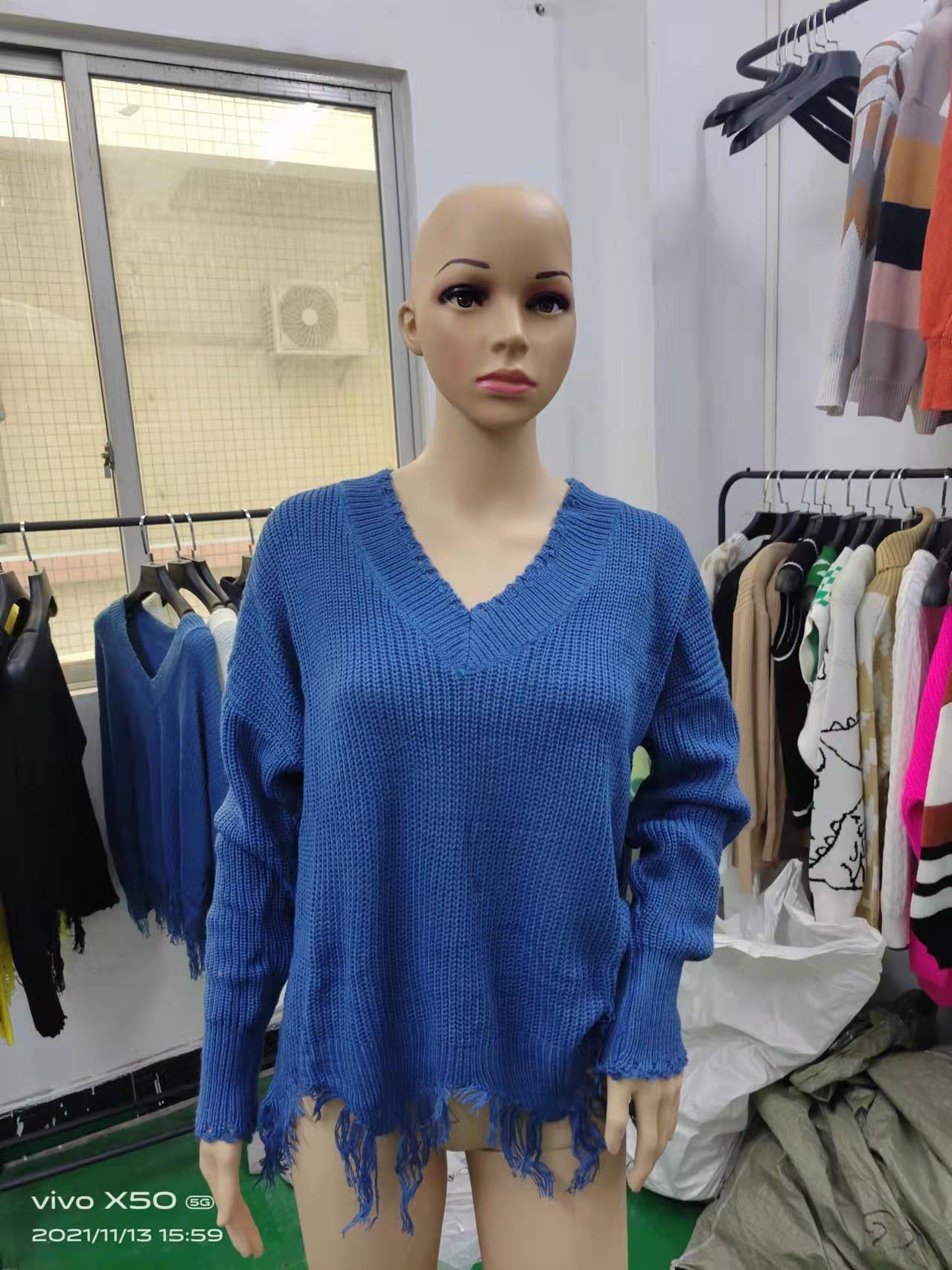 KNIT SWEATER WITH LARGE V-NECK FRINGE HEM