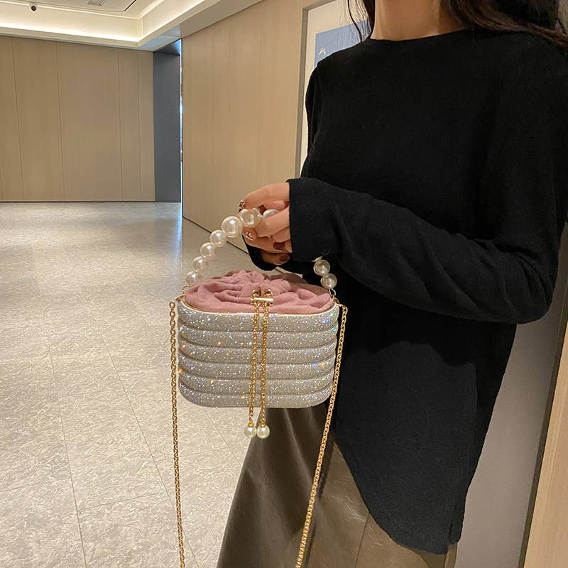 Slung over a pearl sparkling handbag