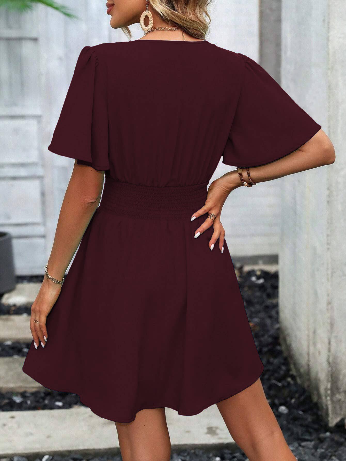 A deep V-neck, lotus leaf sleeve short dress