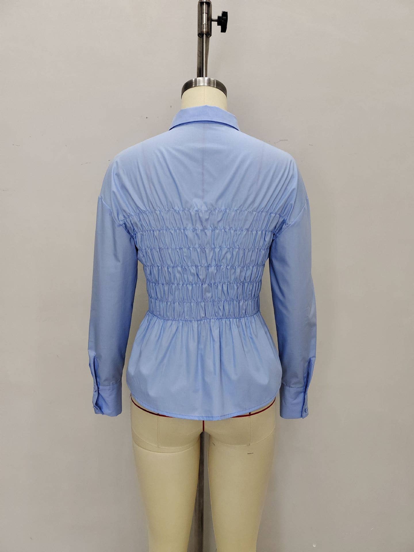 Lapel paired with a pleated cinched-waist shirt