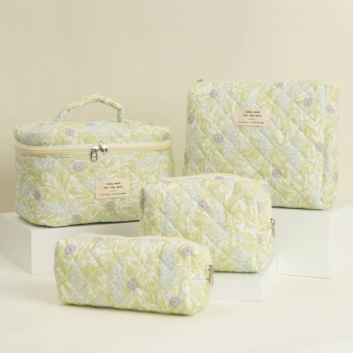 Four-piece set of quilted floral makeup bags