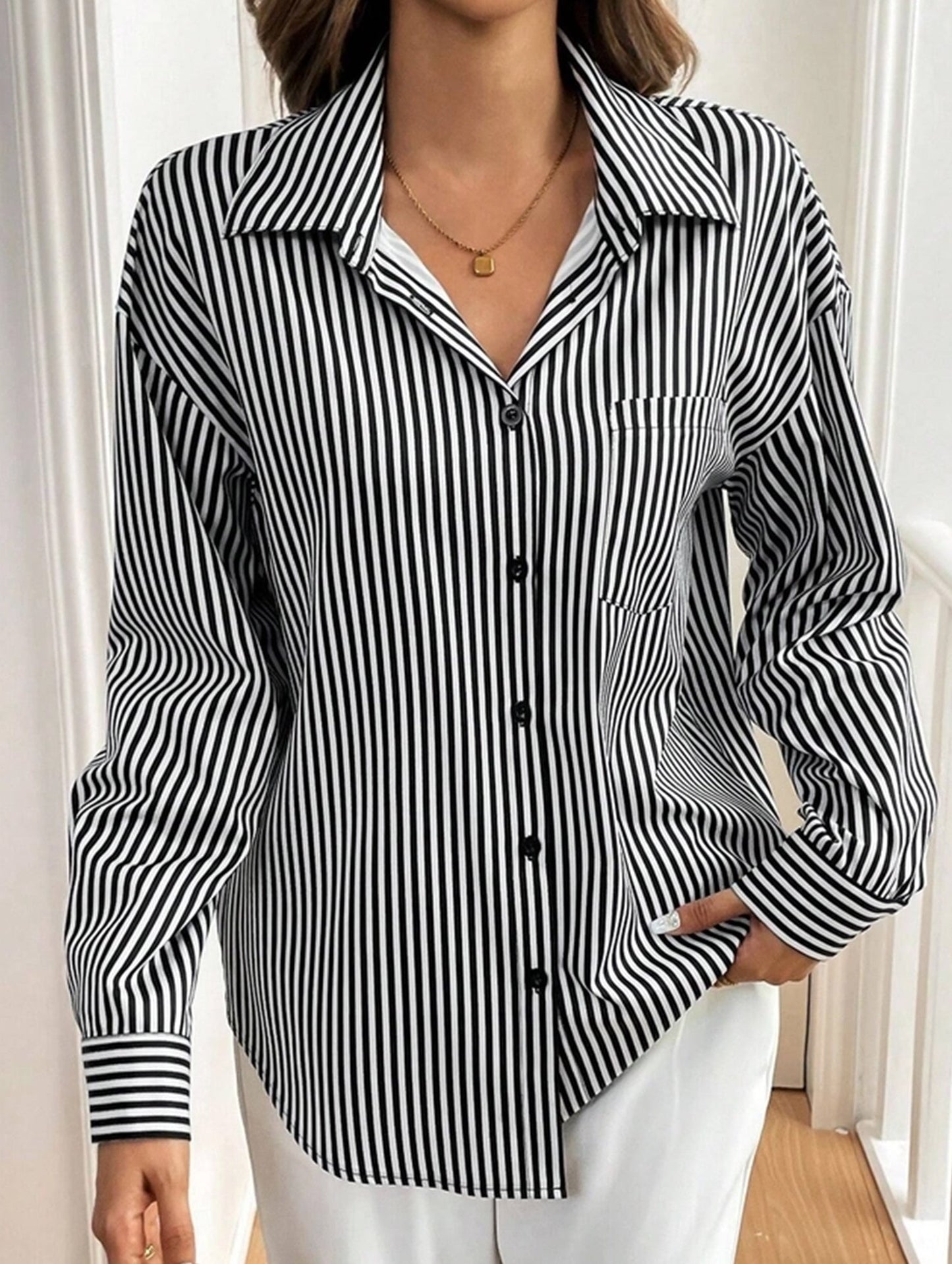 A striped printed long-sleeved shirt with a bow