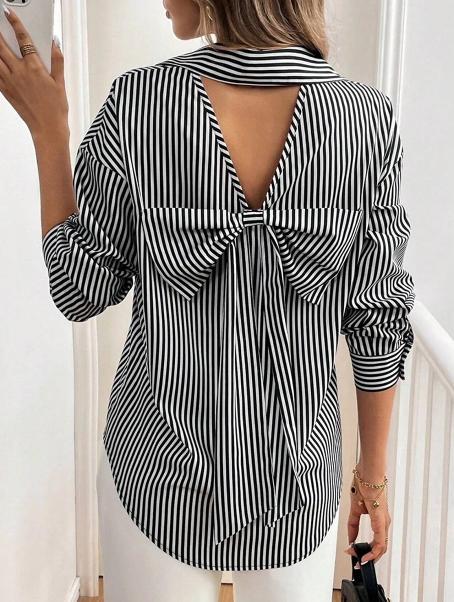 A striped printed long-sleeved shirt with a bow