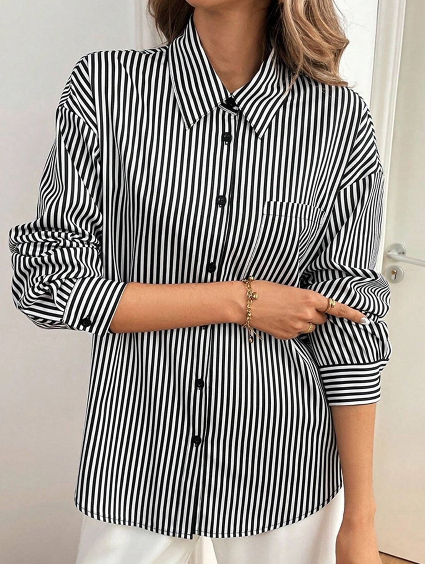 A striped printed long-sleeved shirt with a bow