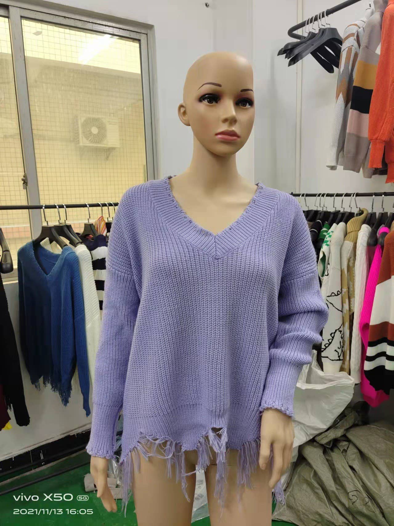 KNIT SWEATER WITH LARGE V-NECK FRINGE HEM