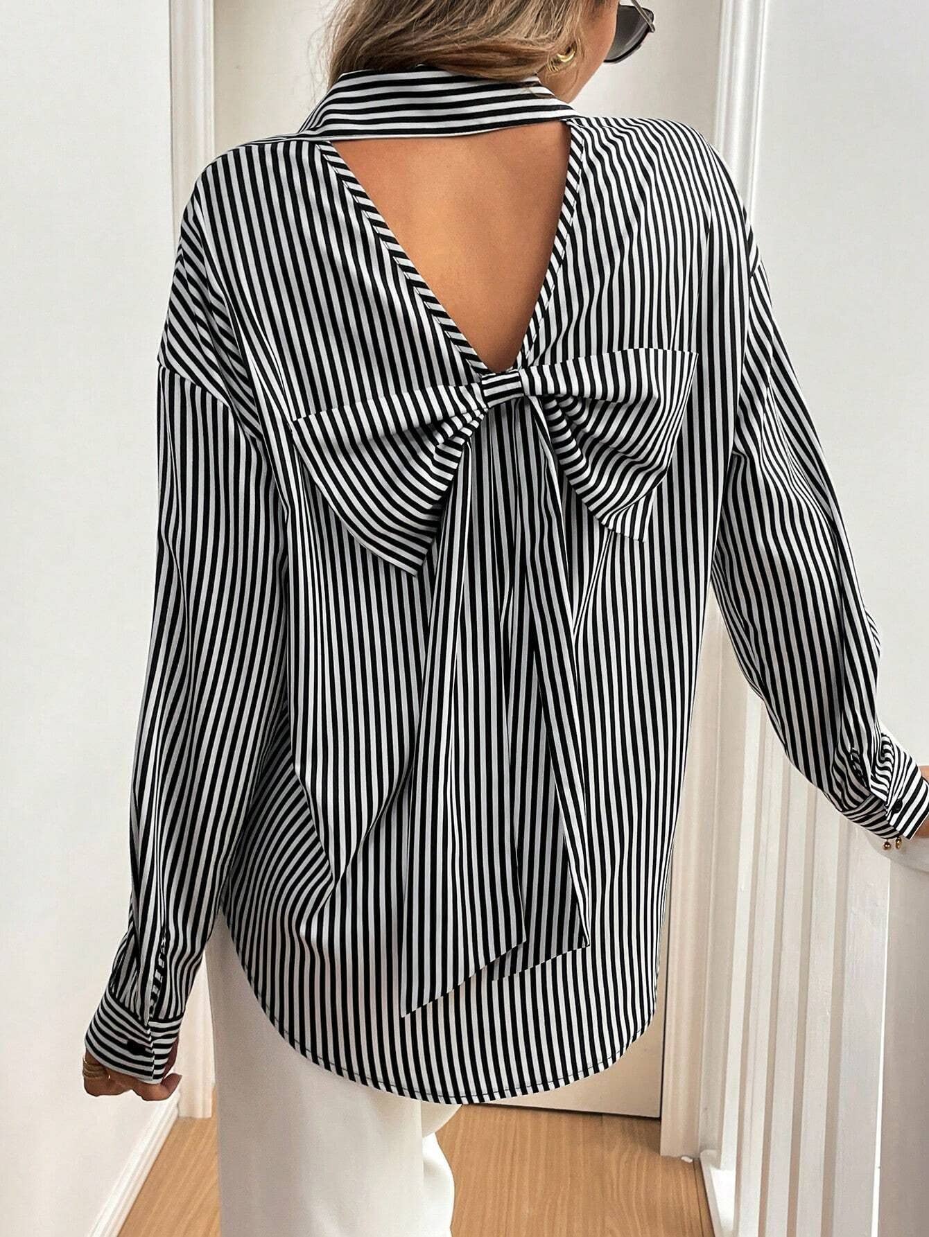 A striped printed long-sleeved shirt with a bow