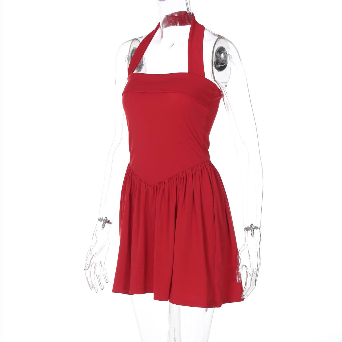 A halter, backless, high-waisted pleated dress