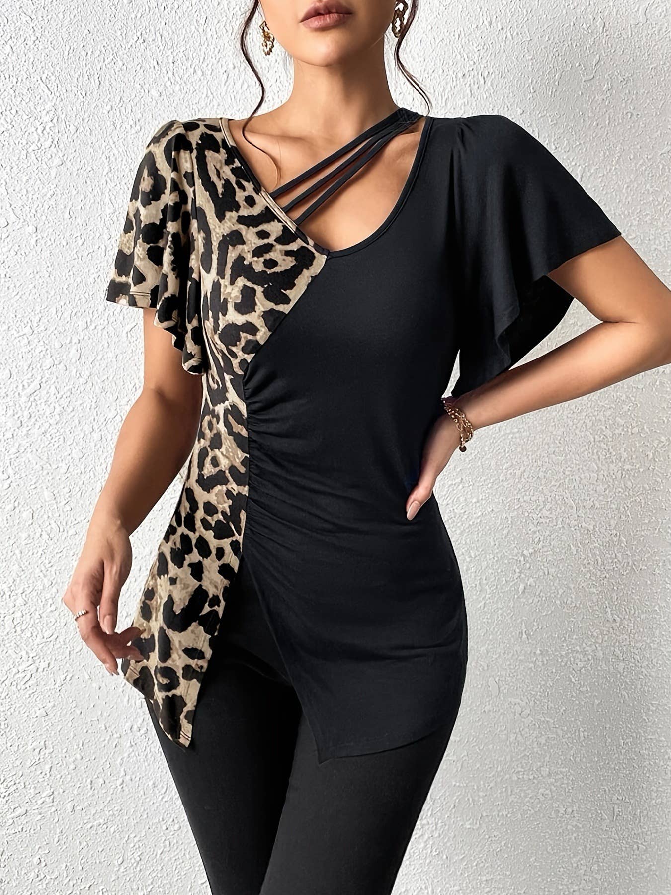 A leopard print asymmetrical collar patchwork top