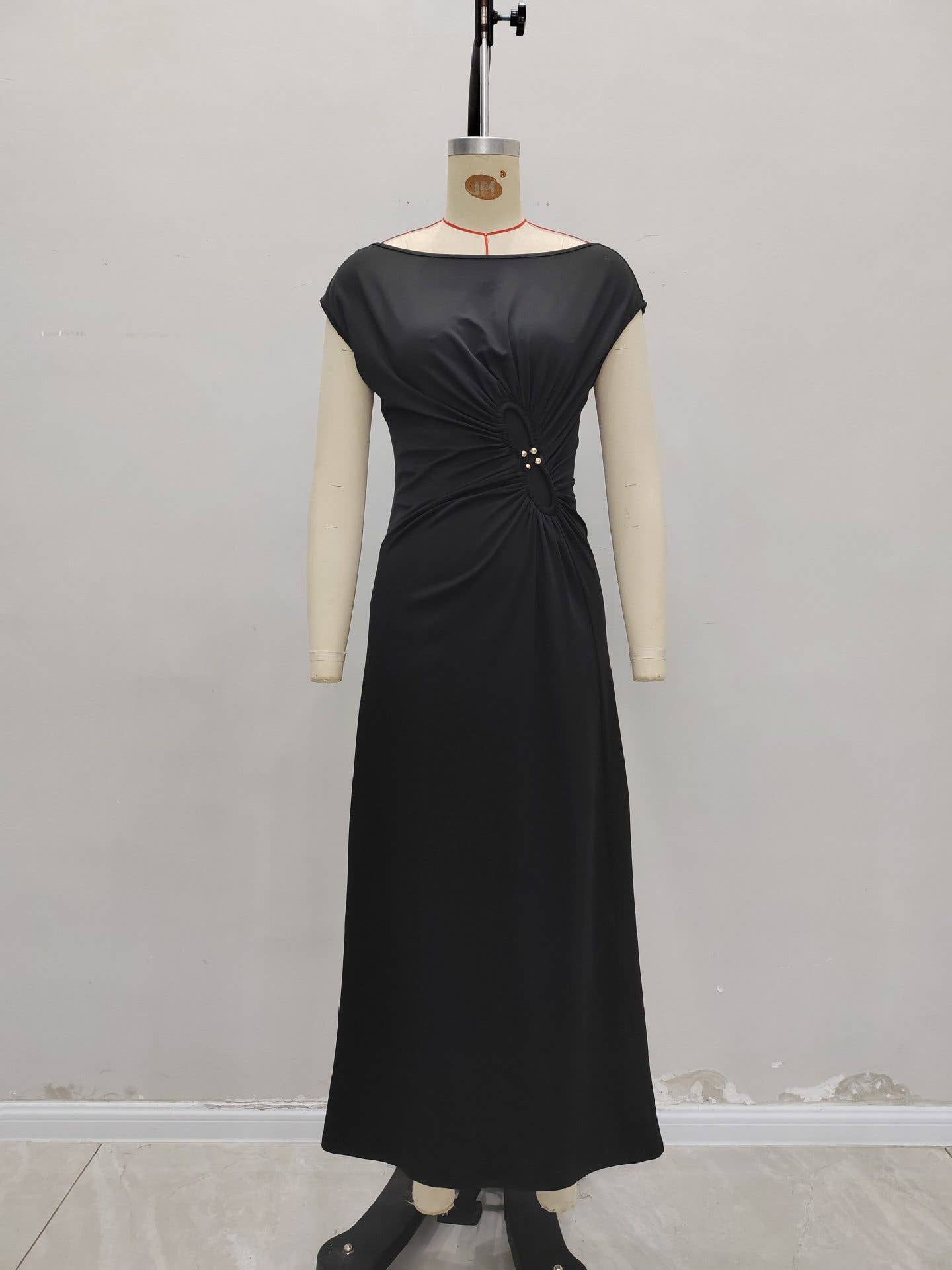 Simple pleated buttons adorn the dress