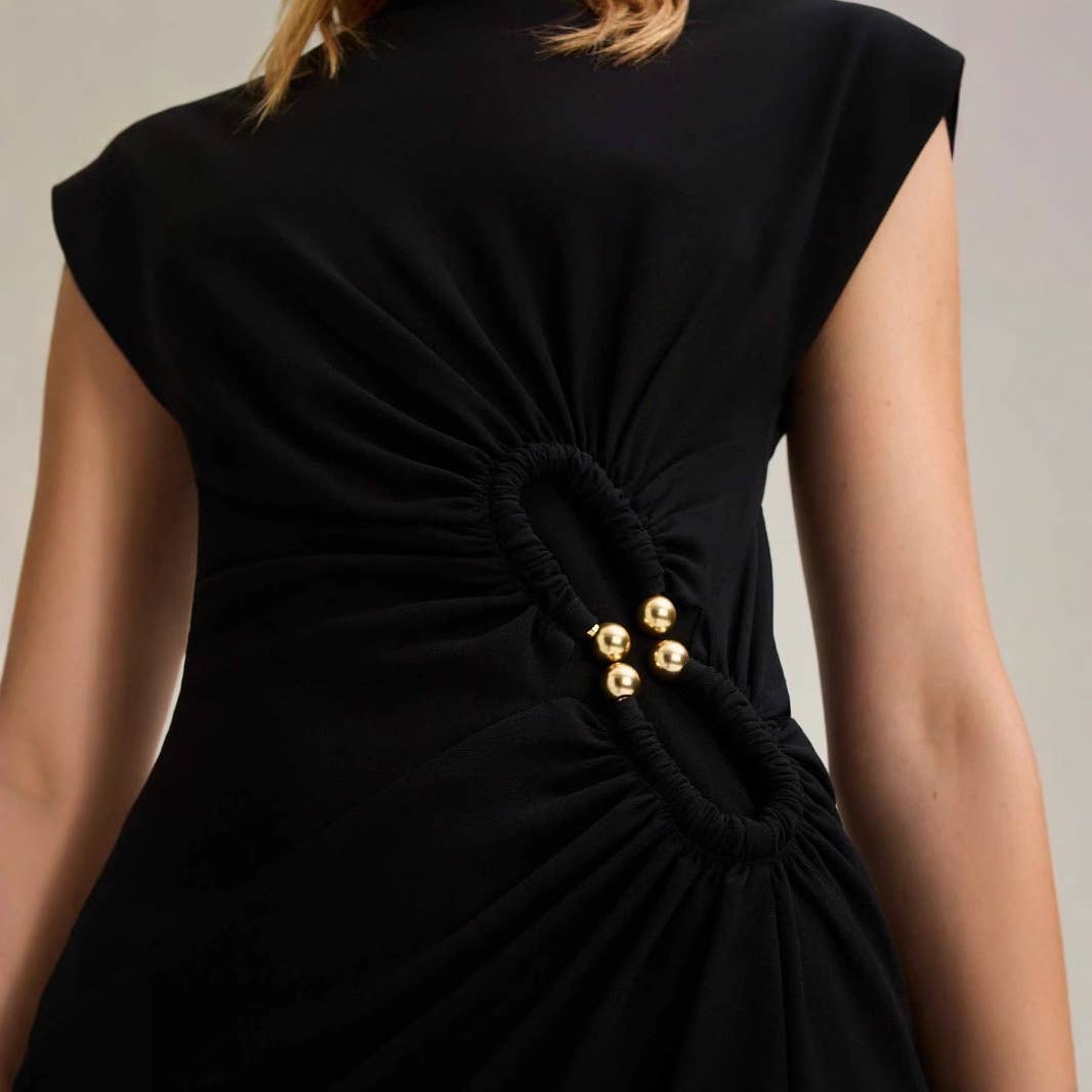 Simple pleated buttons adorn the dress