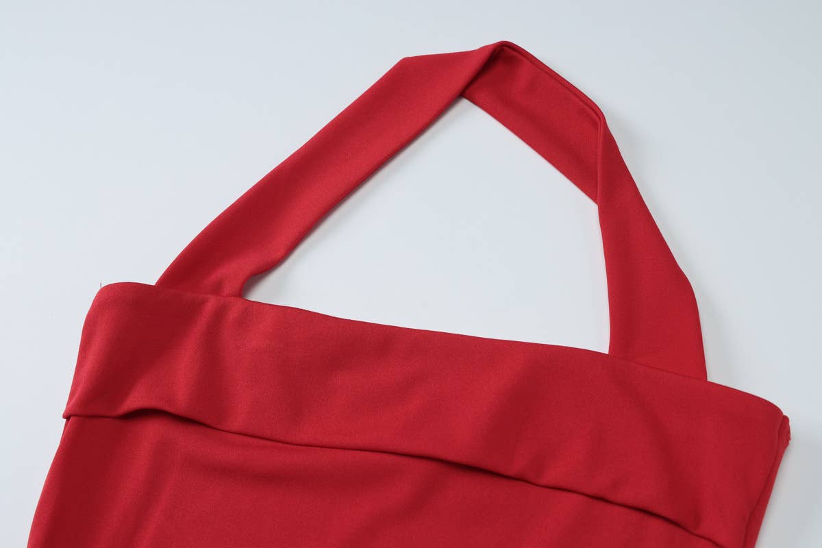 A halter, backless, high-waisted pleated dress