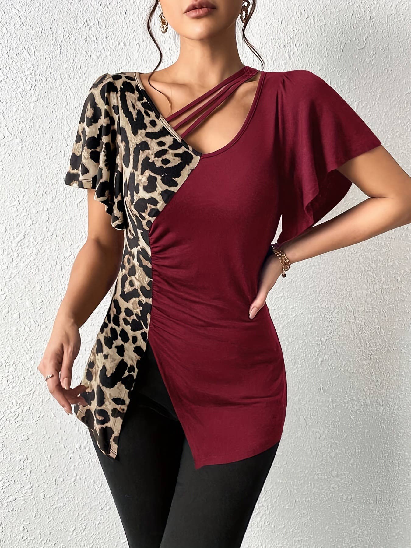 A leopard print asymmetrical collar patchwork top