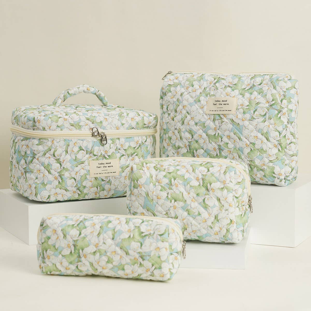 Four-piece set of quilted floral makeup bags