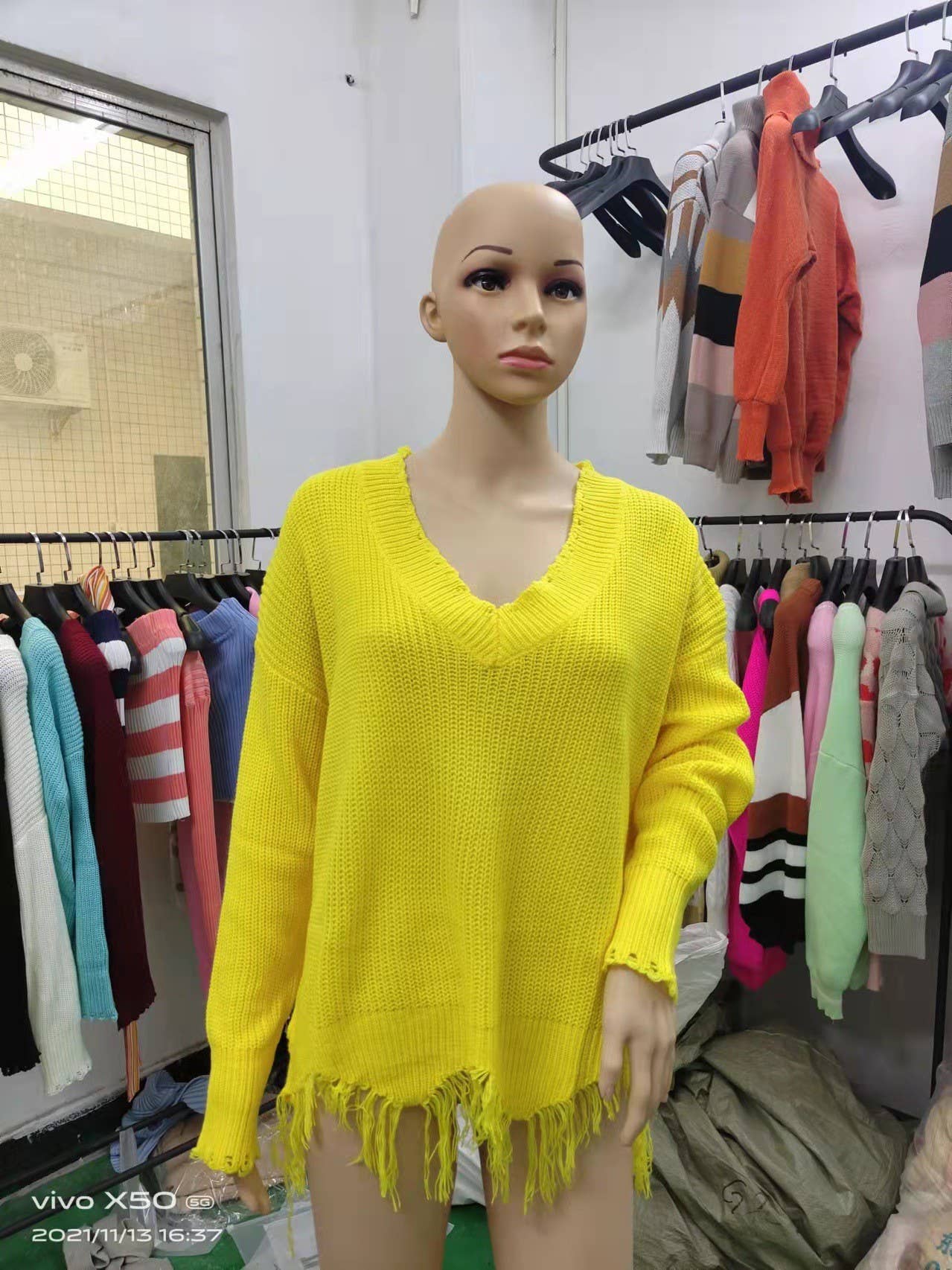 KNIT SWEATER WITH LARGE V-NECK FRINGE HEM