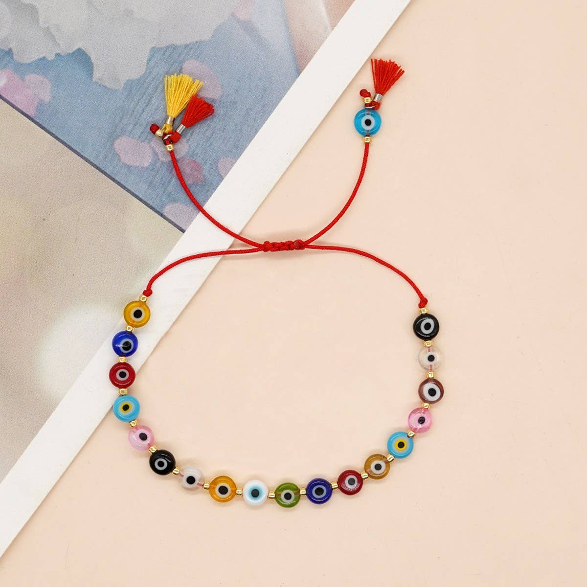 MIXED COLOR GLASS DISC EYE SMALL TASSEL BRACELET
