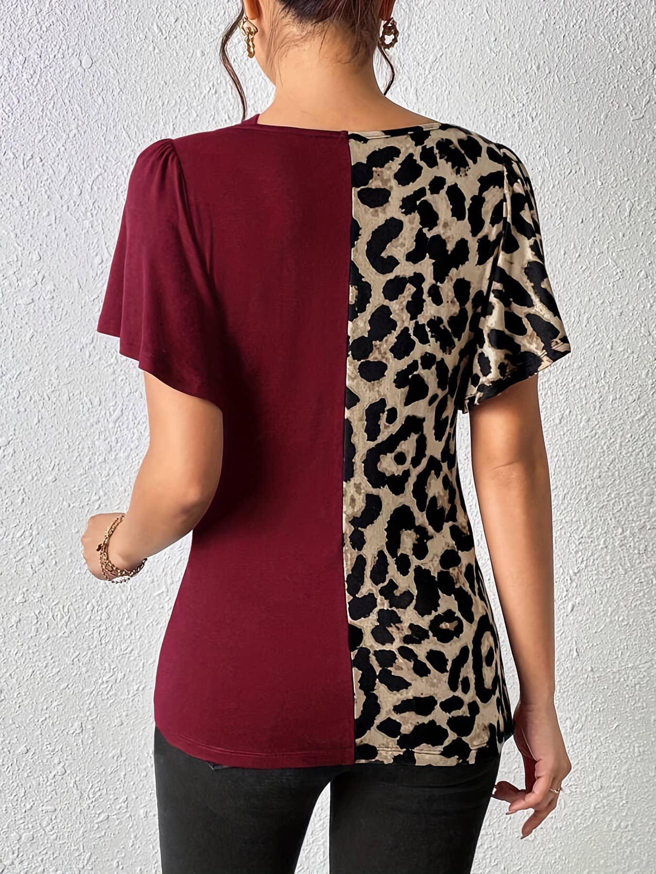A leopard print asymmetrical collar patchwork top